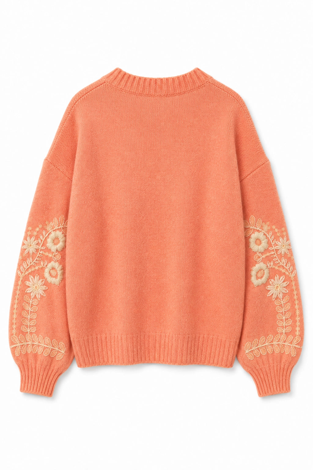 A peach-colored knit sweater with cream-colored floral embroidery on the sleeves, shown from the back against a plain white background.