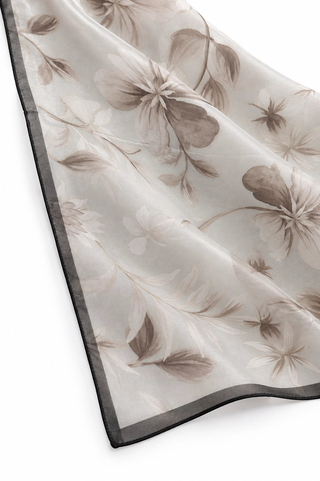 A sheer square scarf with a brown floral and leaf pattern on a light beige background, finished with a contrasting dark gray border, shown draped on a white background.