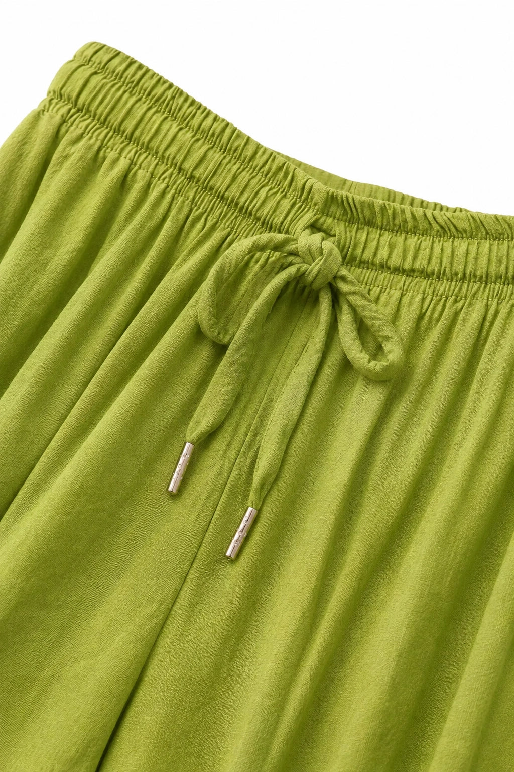 Close-up of olive green drawstring shorts showing the elastic waistband and tie detail against a white background.