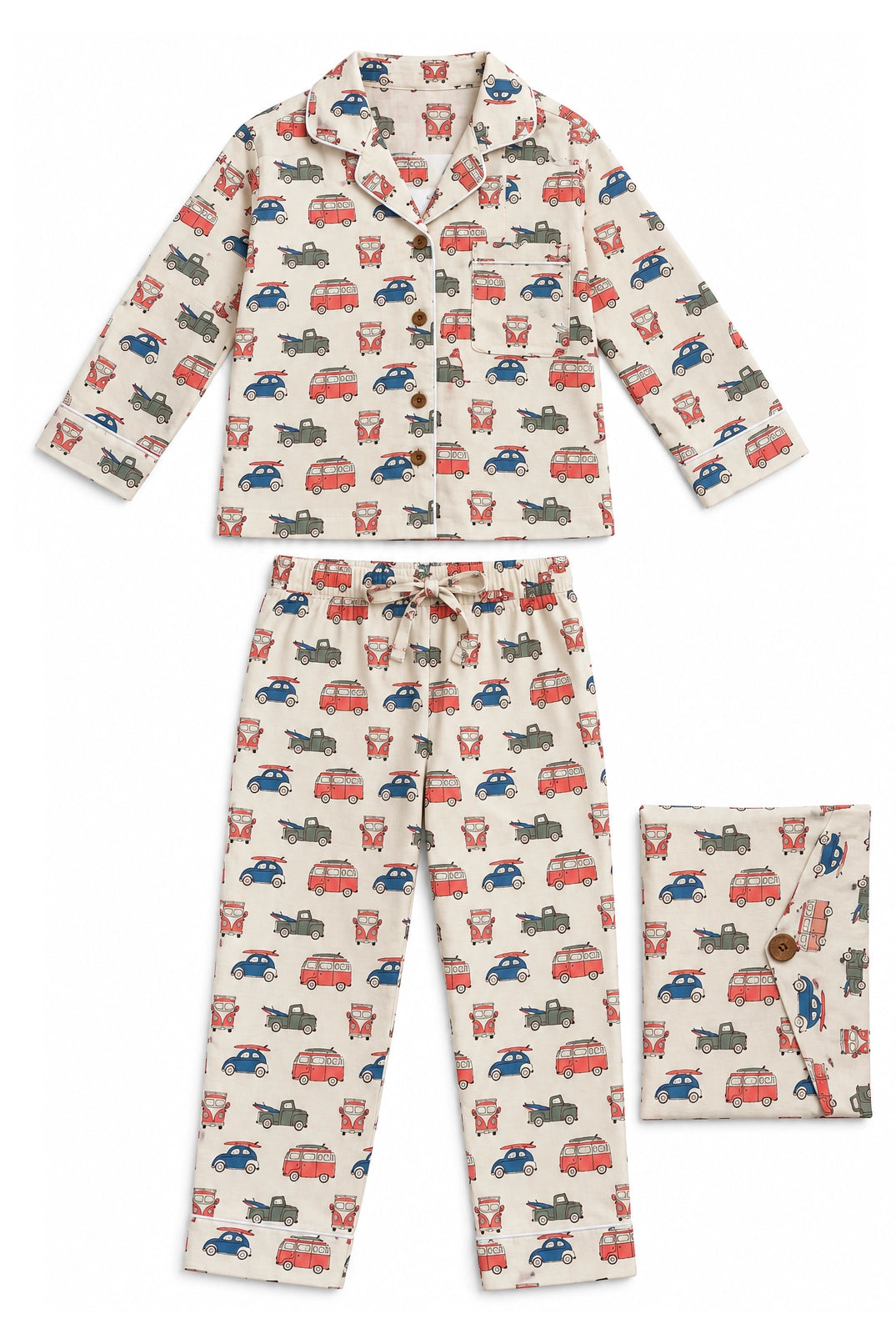 A two-piece children's pajama set featuring a long-sleeve button-front top and matching pants, both in an off-white fabric with an all-over repeating print of red, blue, and gray vintage buses. A matching folded pocket flap is shown on the right.
