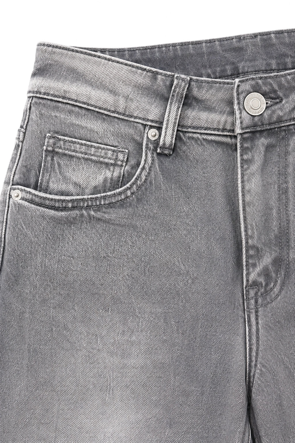 Close-up of gray denim jeans showing the waistband, belt loops, right front pocket, button, and stitching details.