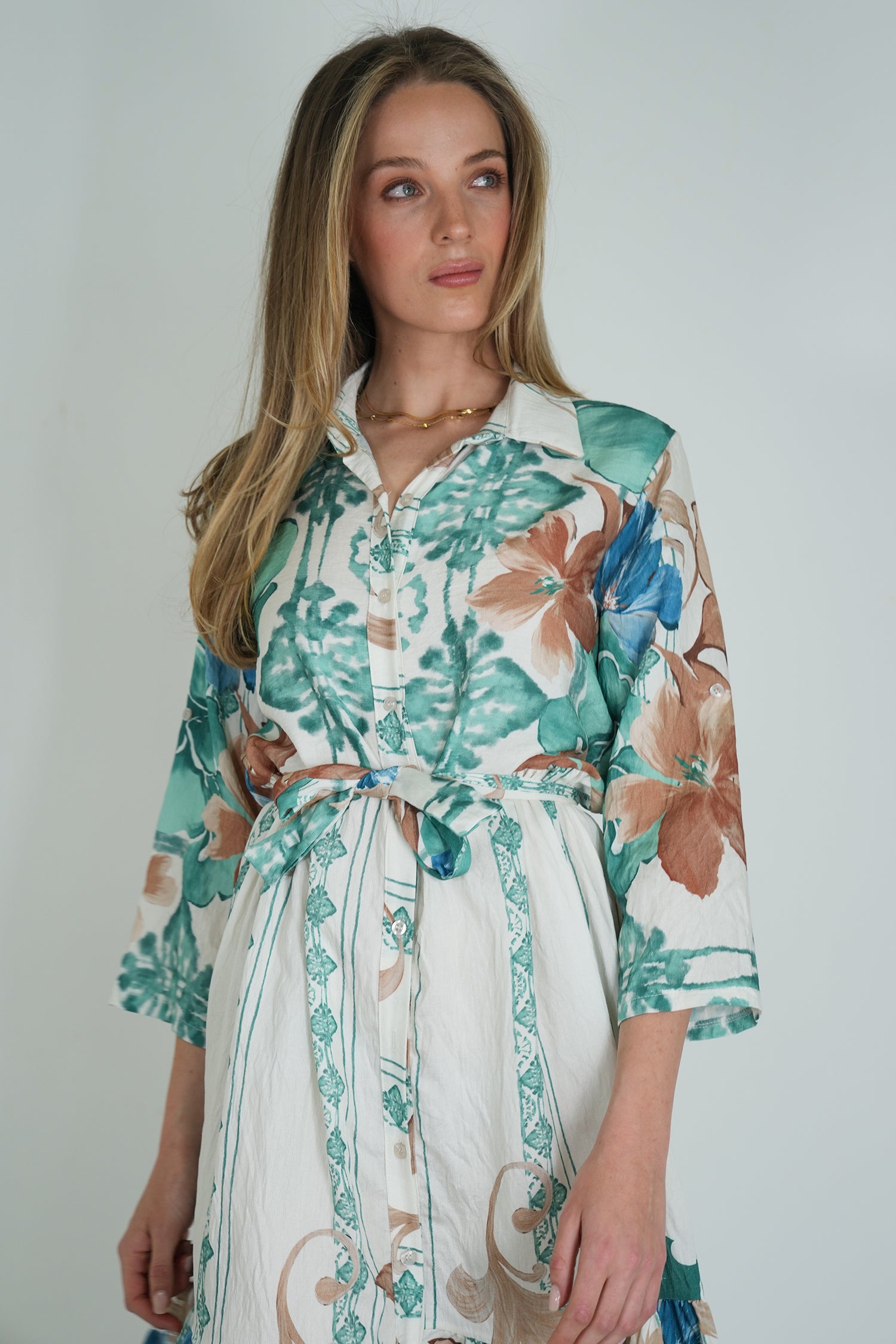 Woman wearing a floral dress with a white background