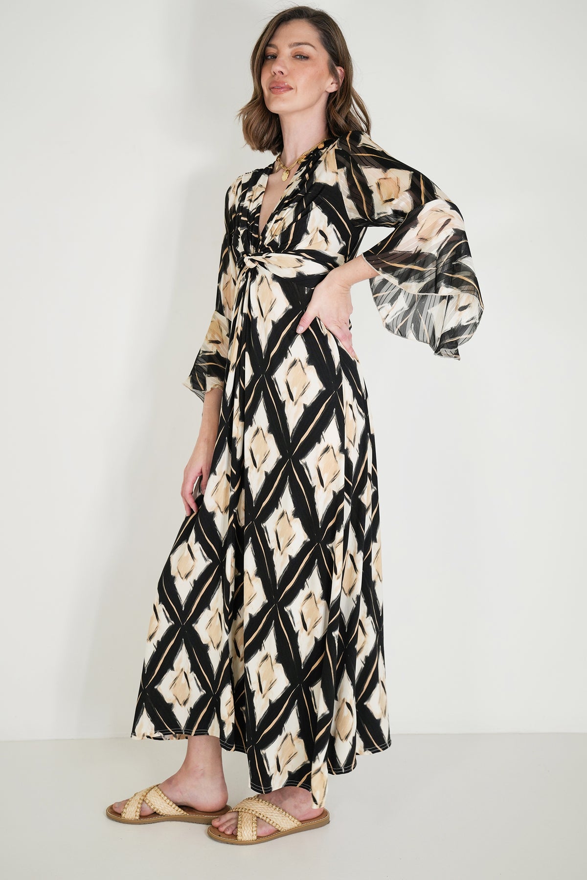 Woman wearing a patterned dress with a white background