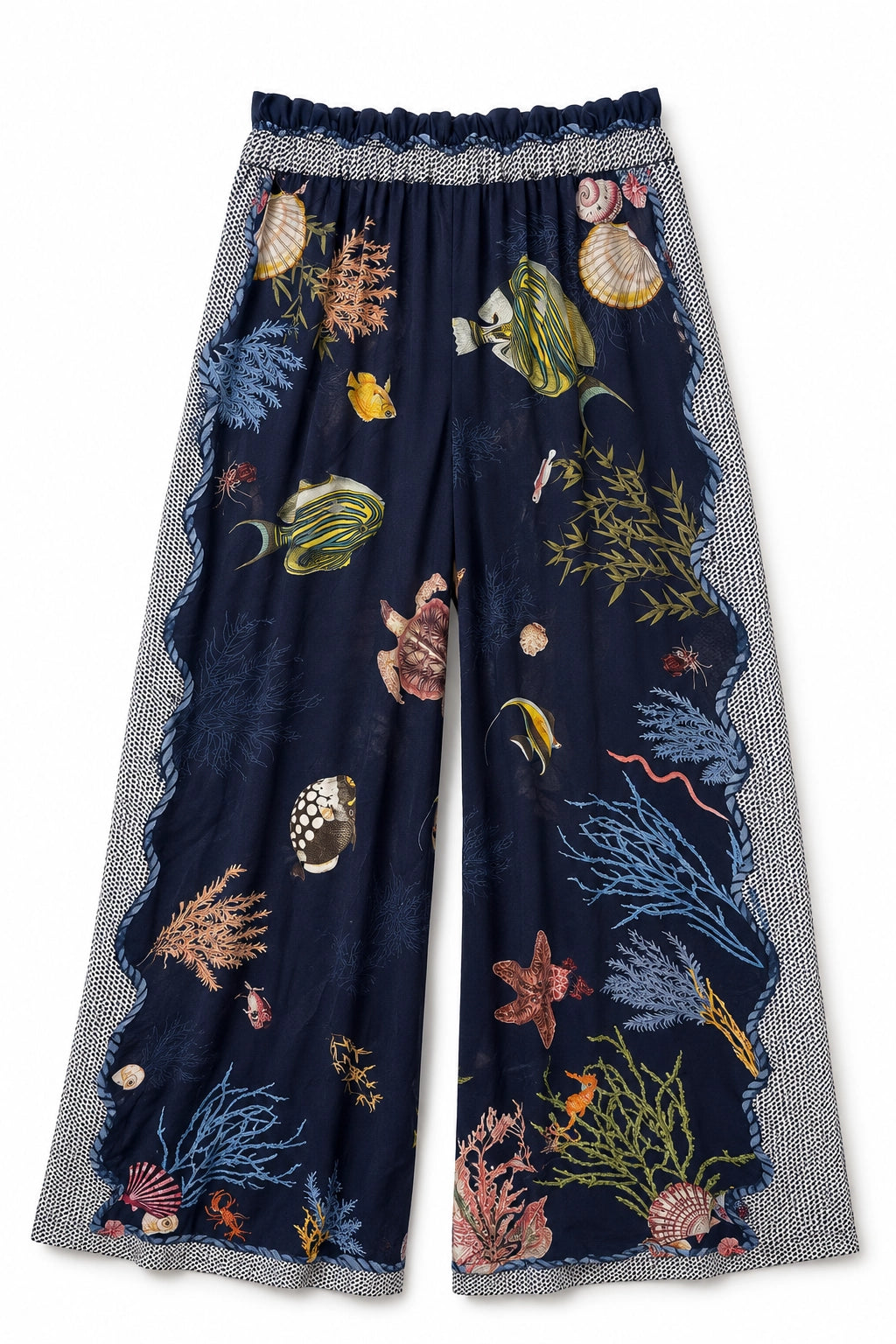 A pair of wide-leg pants featuring a dark navy blue base with an all-over underwater print of fish, starfish, coral, and seashells, finished with a gray and white patterned scalloped border.