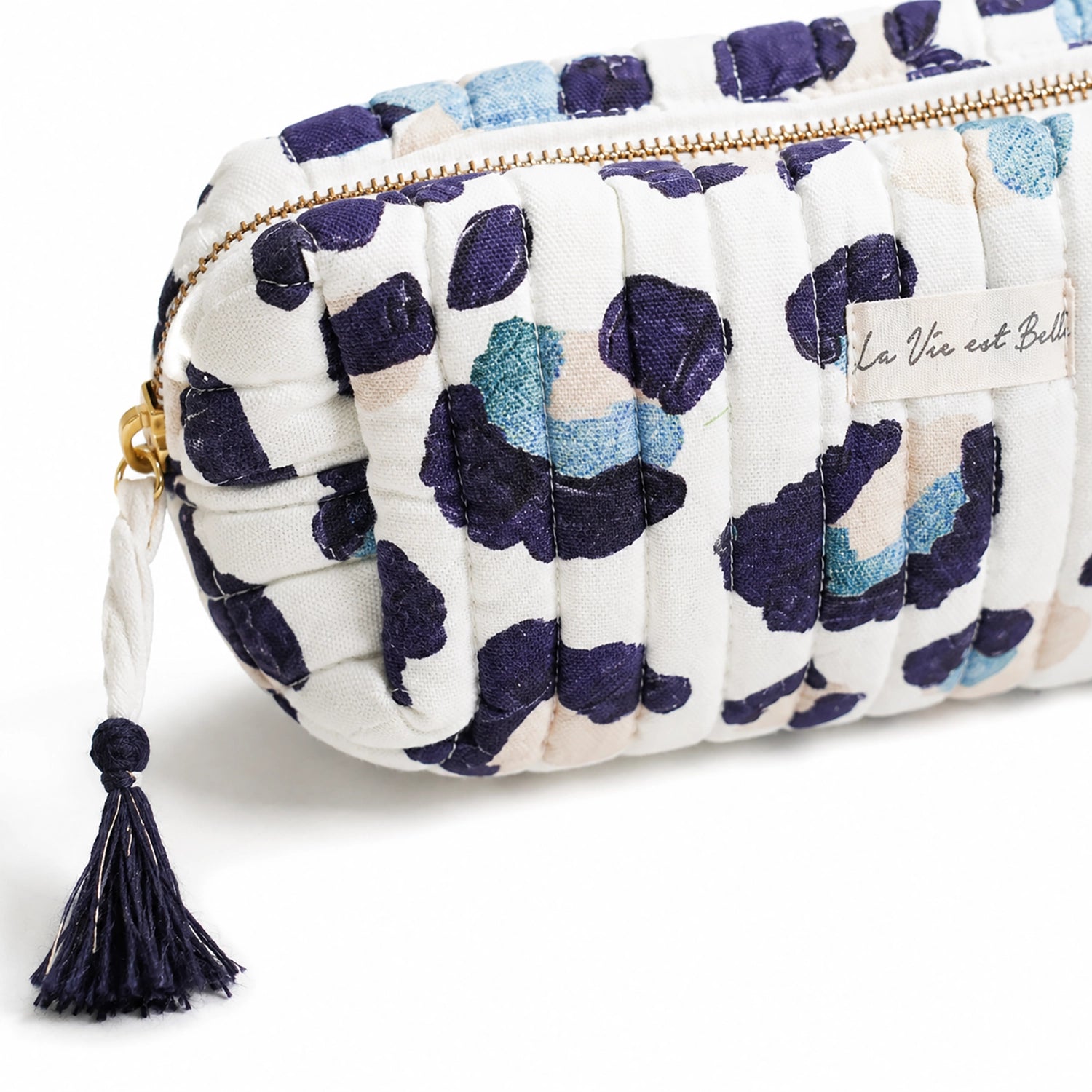 Floral patterned pouch with tassel on a white background