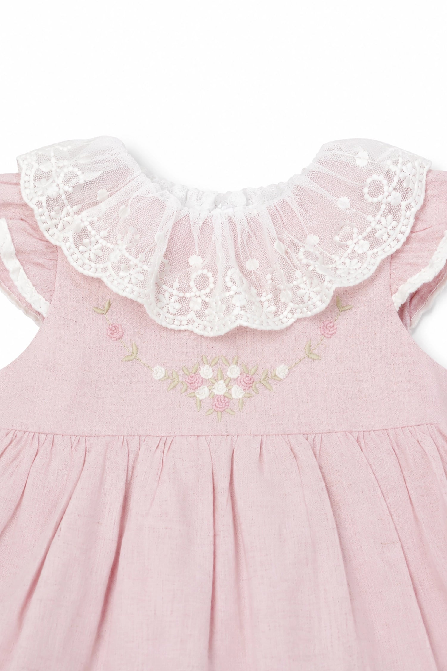 Pink dress with floral embroidery and lace collar on a white background