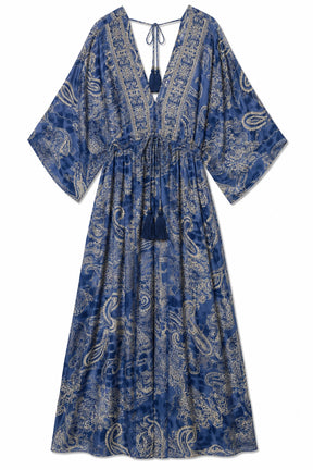 A blue kaftan dress with a beige paisley pattern, featuring wide sleeves, a V-neckline with tassel ties, and a drawstring waist.