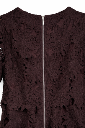 Close-up of a dark brown lace garment with a zipper.