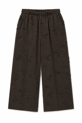 Dark brown wide-leg cropped pants with an all-over tonal floral jacquard pattern, featuring an elastic waistband.