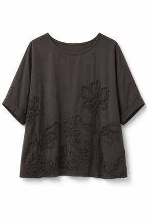 A dark brown short-sleeve top with tonal floral embroidery on the front, displayed against a plain white background.