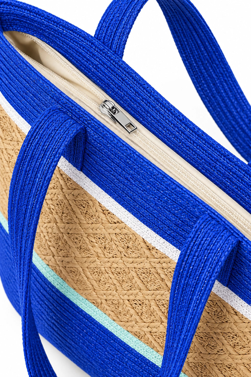 Close-up of a woven tote bag with bright blue handles and trim, a natural tan woven body, and thin white and mint blue stripes, shown on a white background.