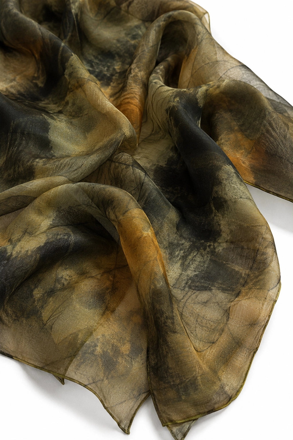 A lightweight sheer scarf with an abstract tie-dye or watercolor pattern in shades of brown, beige, black, and muted orange, draped elegantly on a white background.