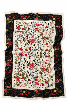 A rectangular scarf with a central cream panel featuring a dense red, pink, and green floral vine pattern, surrounded by a dark navy border with a smaller floral print and a thin cream edge.