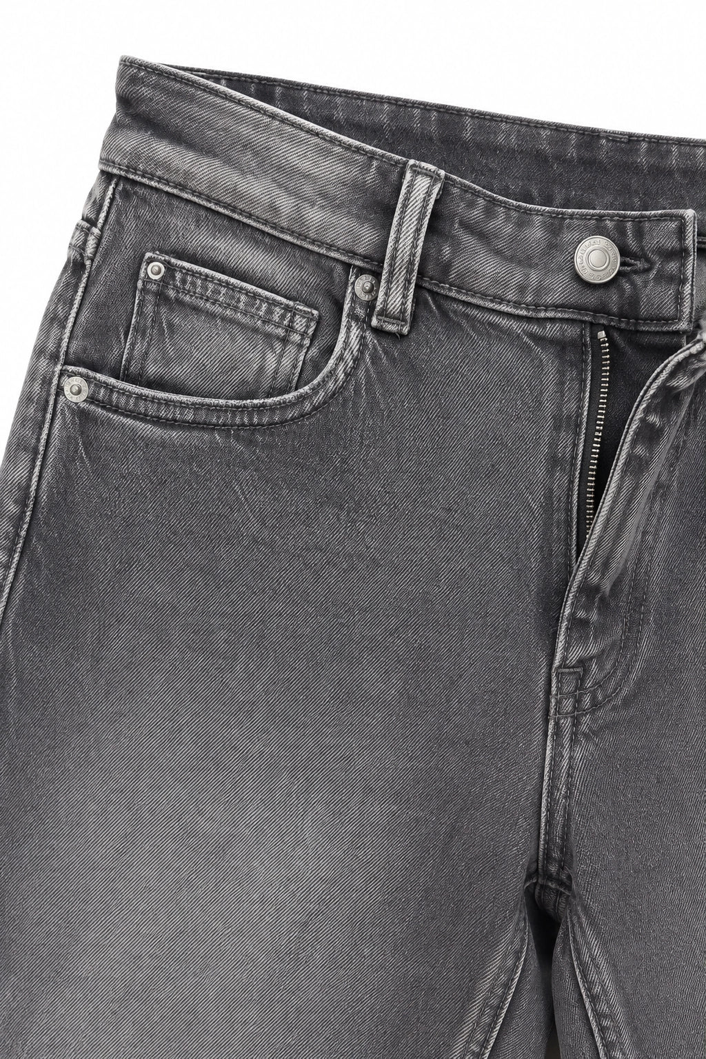 Close-up of dark gray washed denim jeans showing the waistband, belt loop, button, zipper, front pocket, and fabric texture.