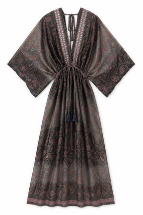A dark brown and black kaftan dress with a red paisley pattern, featuring wide sleeves, a V-neckline with tie details, and a drawstring waist with tassel accents.