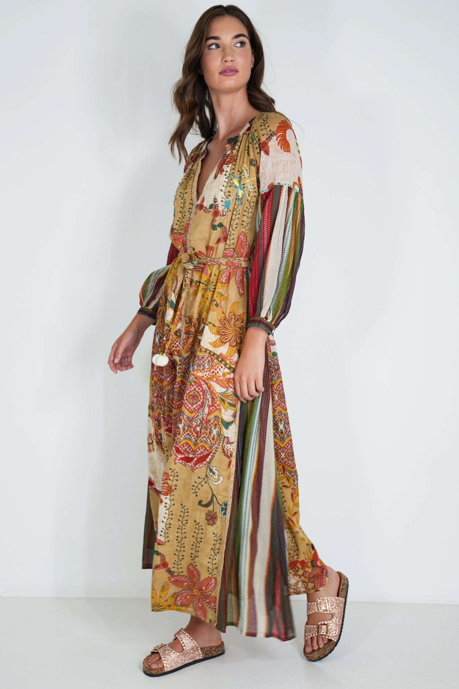Woman wearing a colorful patterned dress on a white background