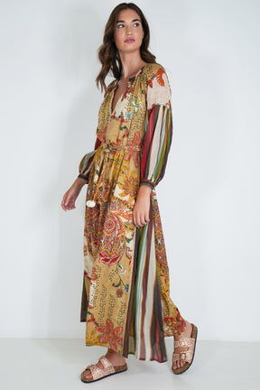 Woman wearing a colorful patterned dress on a white background