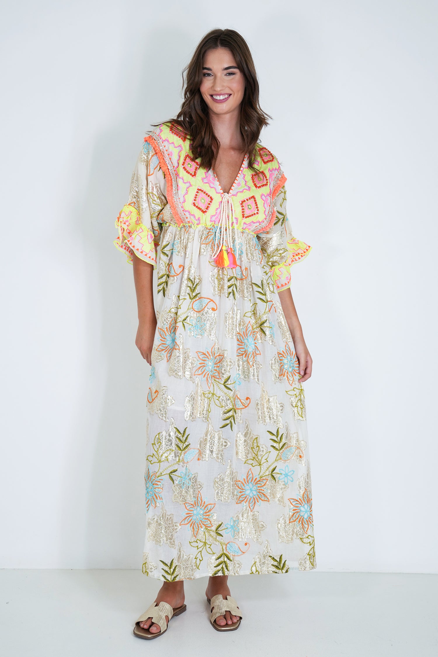 Woman wearing a colorful floral dress with a white background