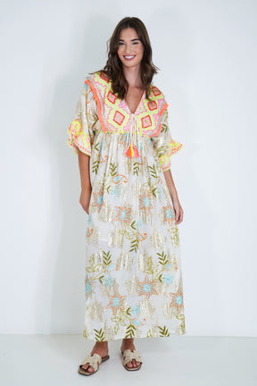 Woman wearing a colorful floral dress with a white background