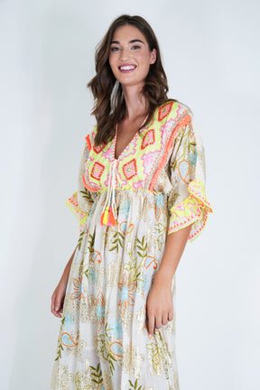 Woman wearing a colorful patterned dress on a white background