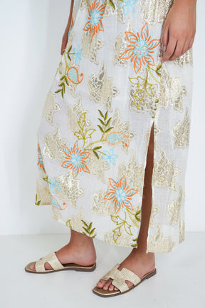 Person wearing a floral dress with a white background