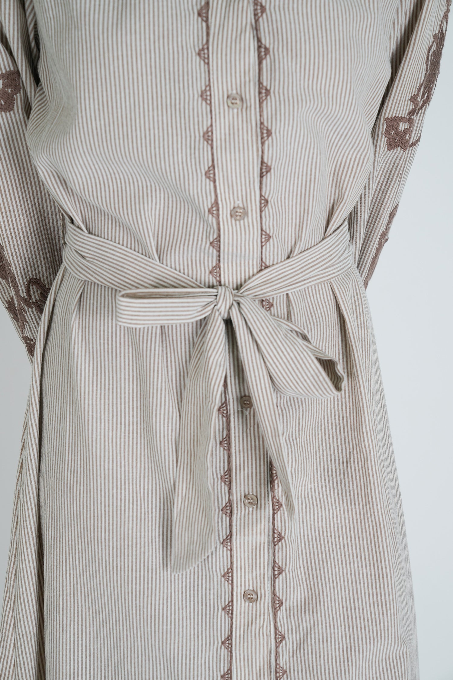 Striped dress with lace trim on a white background