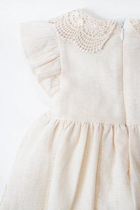 Cream-colored dress with crochet details on a white background