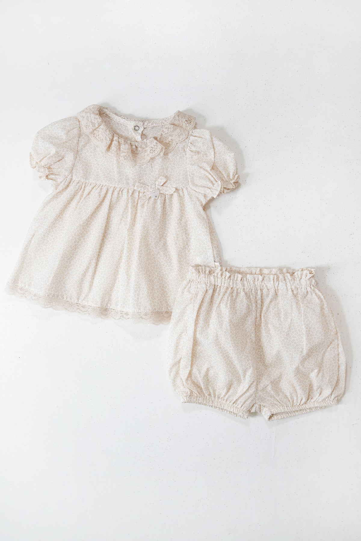 Baby dress and bloomers set on a white background