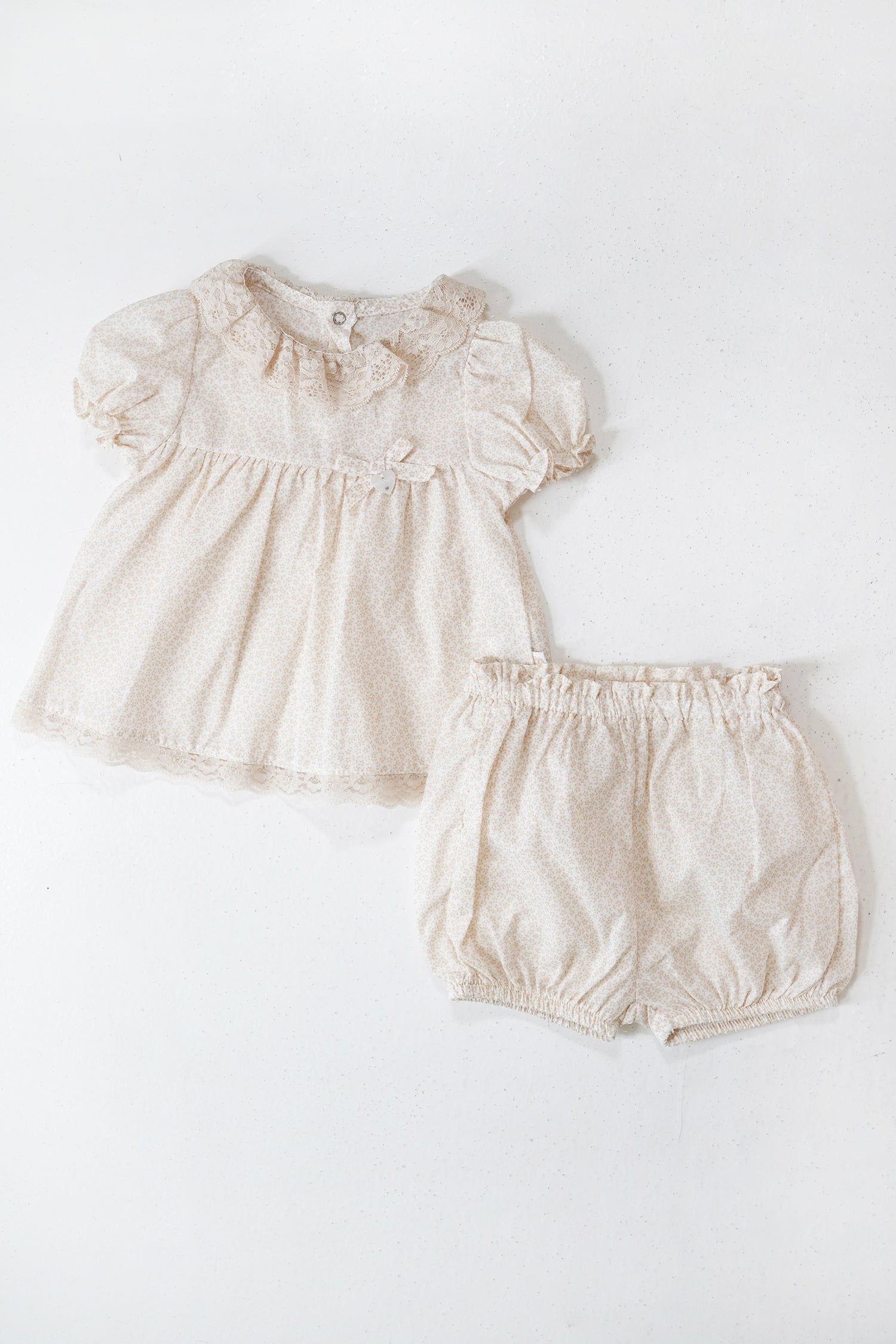 Baby dress and bloomers set on a white background