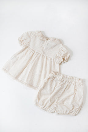 Beige baby romper with ruffled sleeves on a white background
