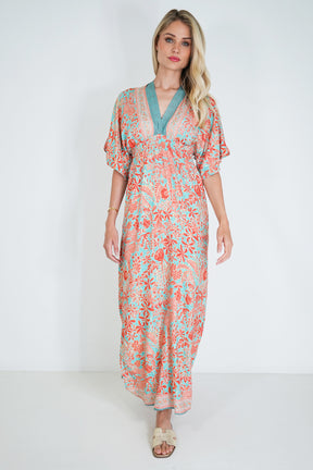 Woman wearing a floral dress with a plain background