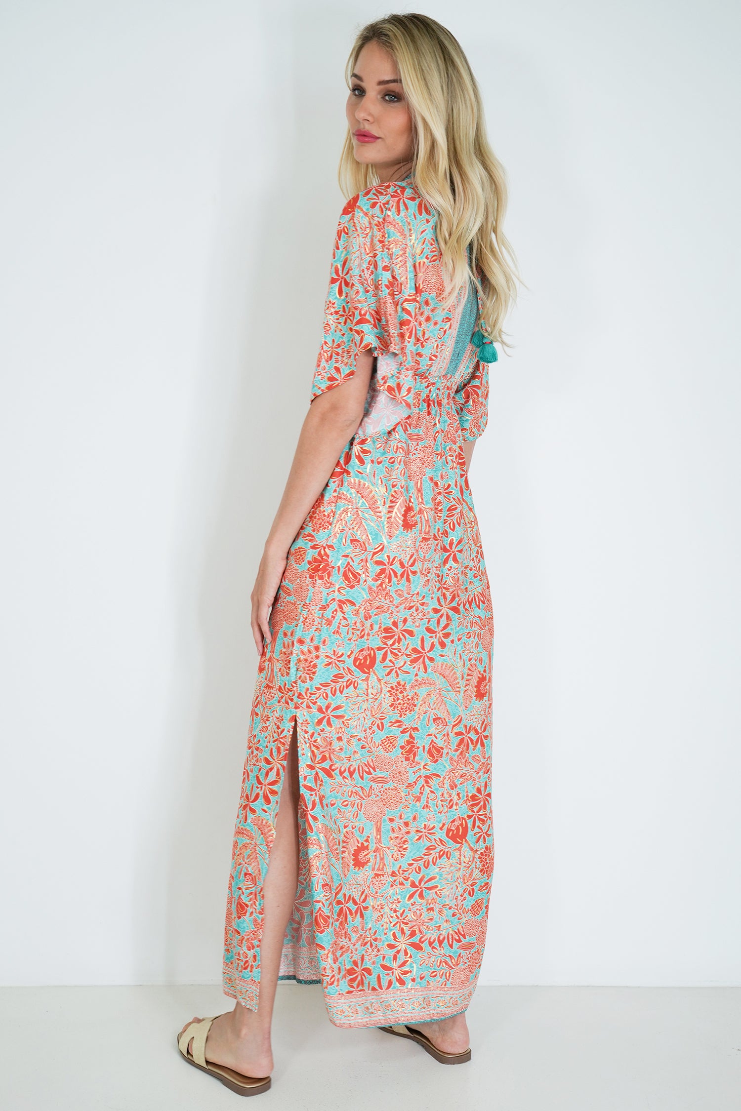 Woman wearing a floral dress with a white background