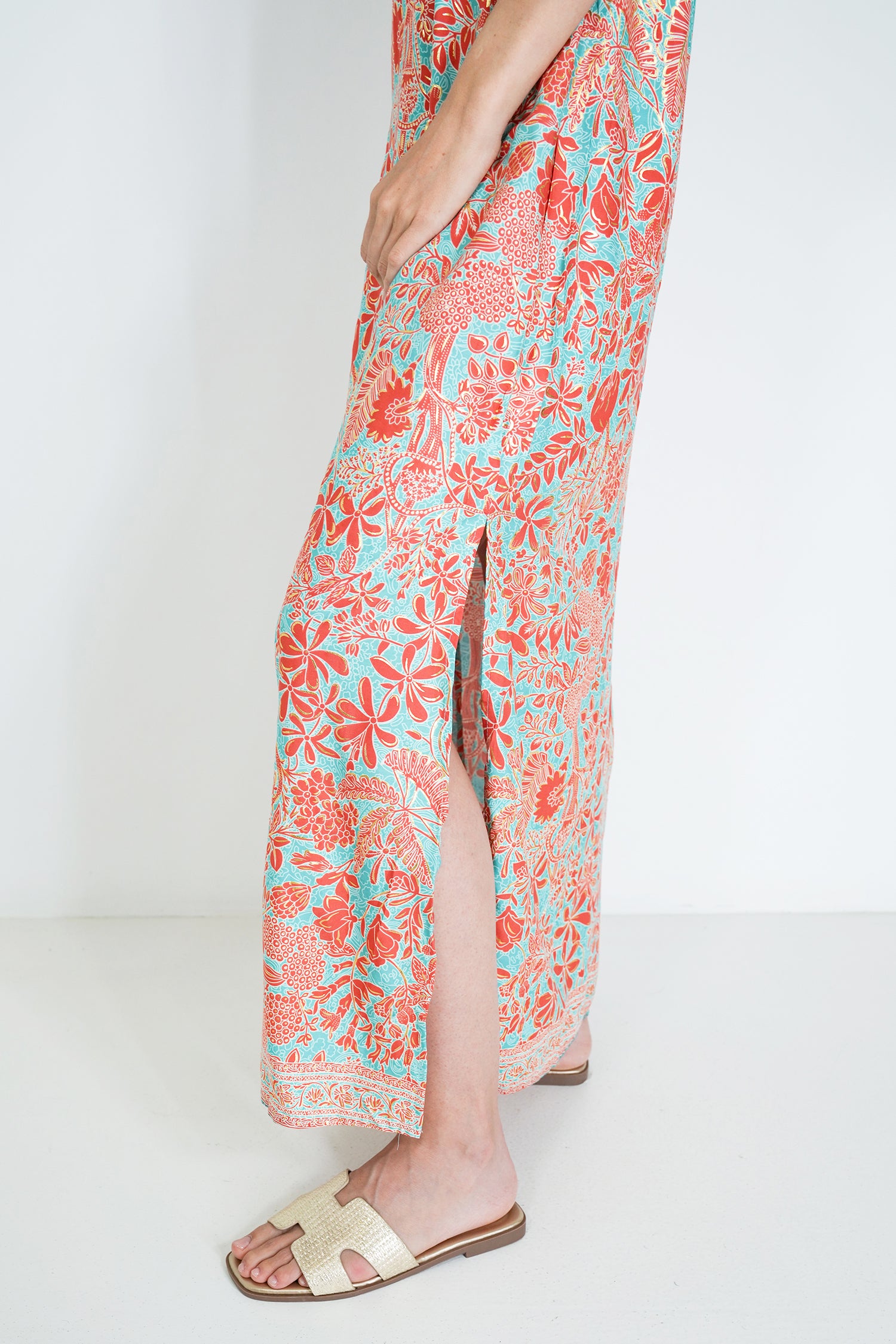 Person wearing a floral dress with a white background