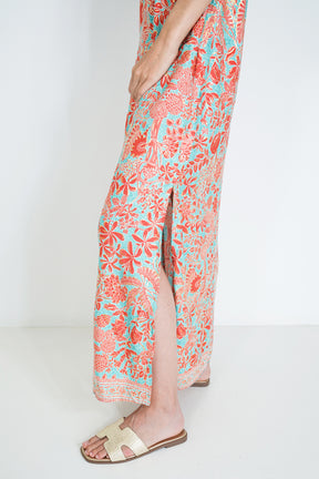 Person wearing a floral dress with a white background