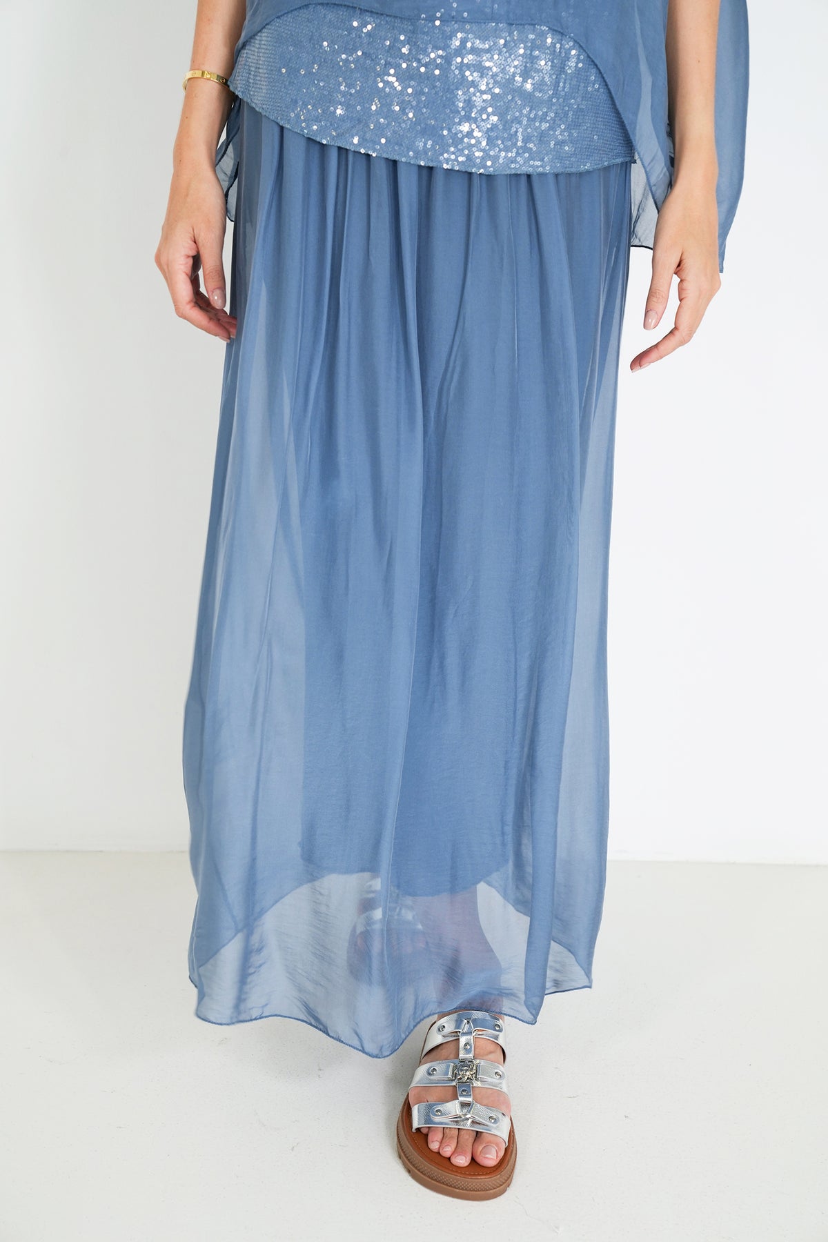 Blue dress with sequin top on a white background