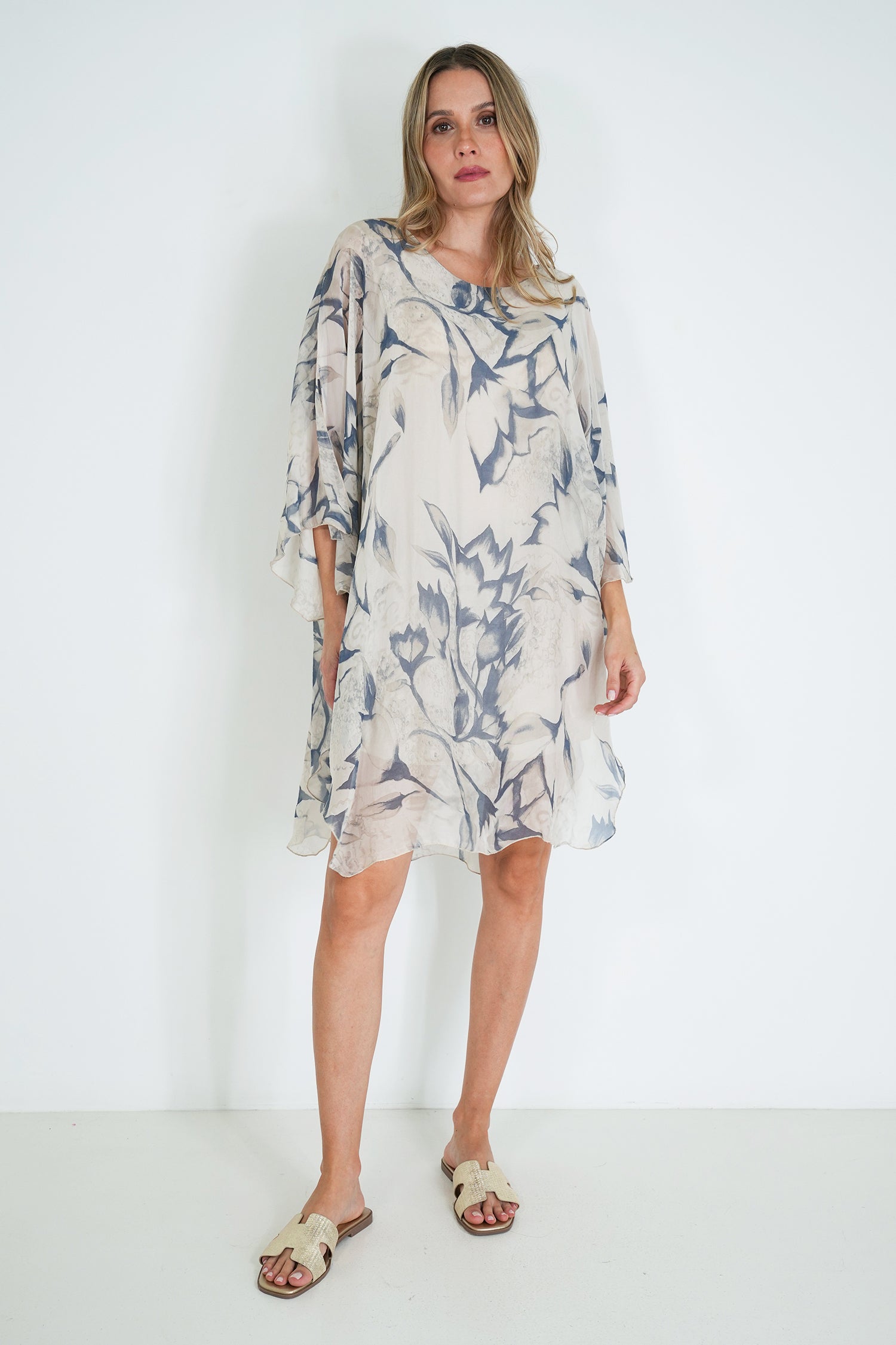 Woman wearing a floral dress against a white background