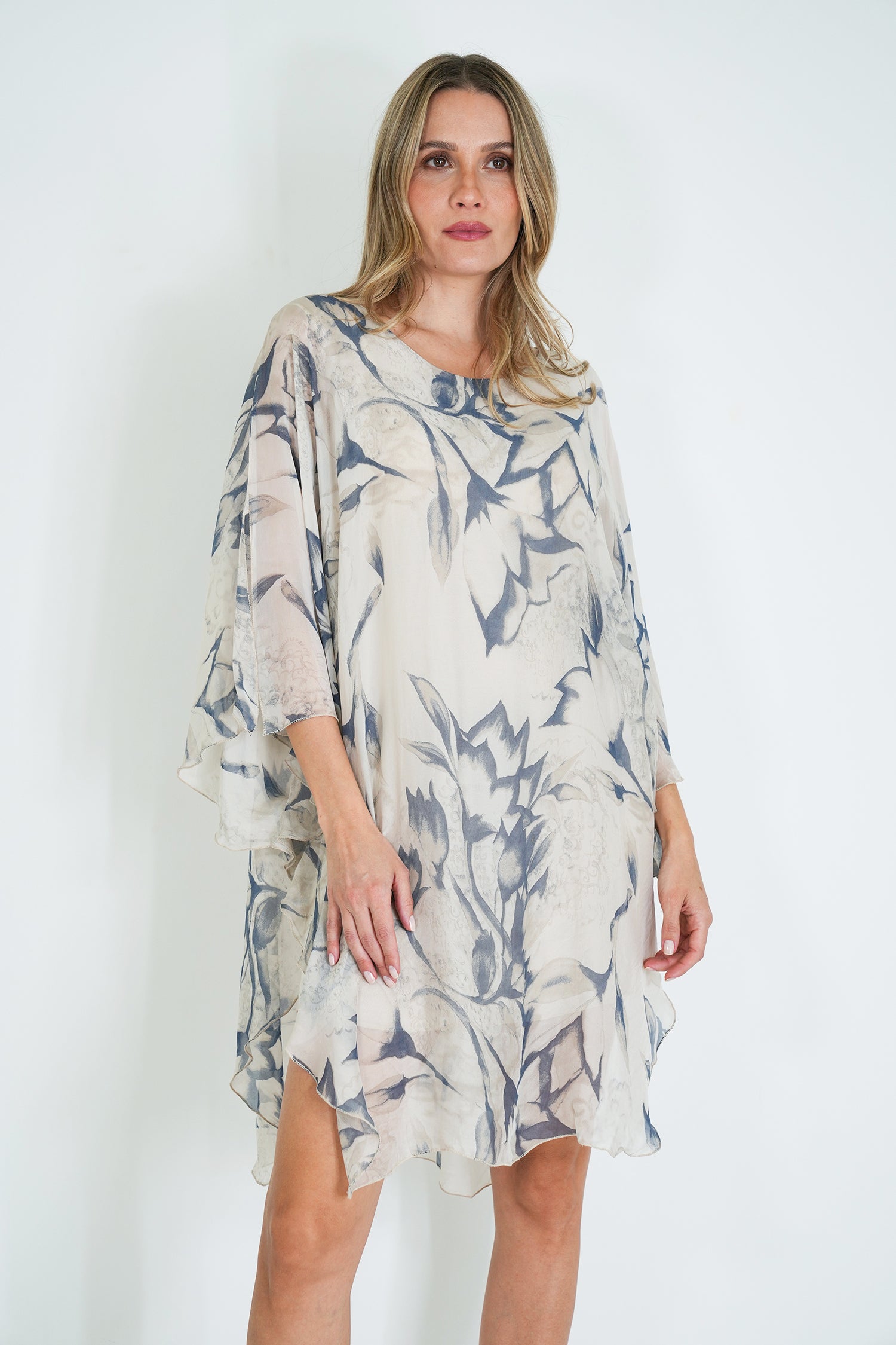 Woman wearing a floral dress against a white background