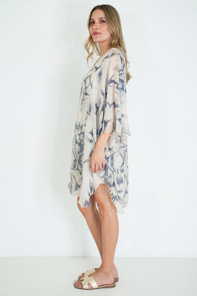 Woman wearing a floral dress against a white background