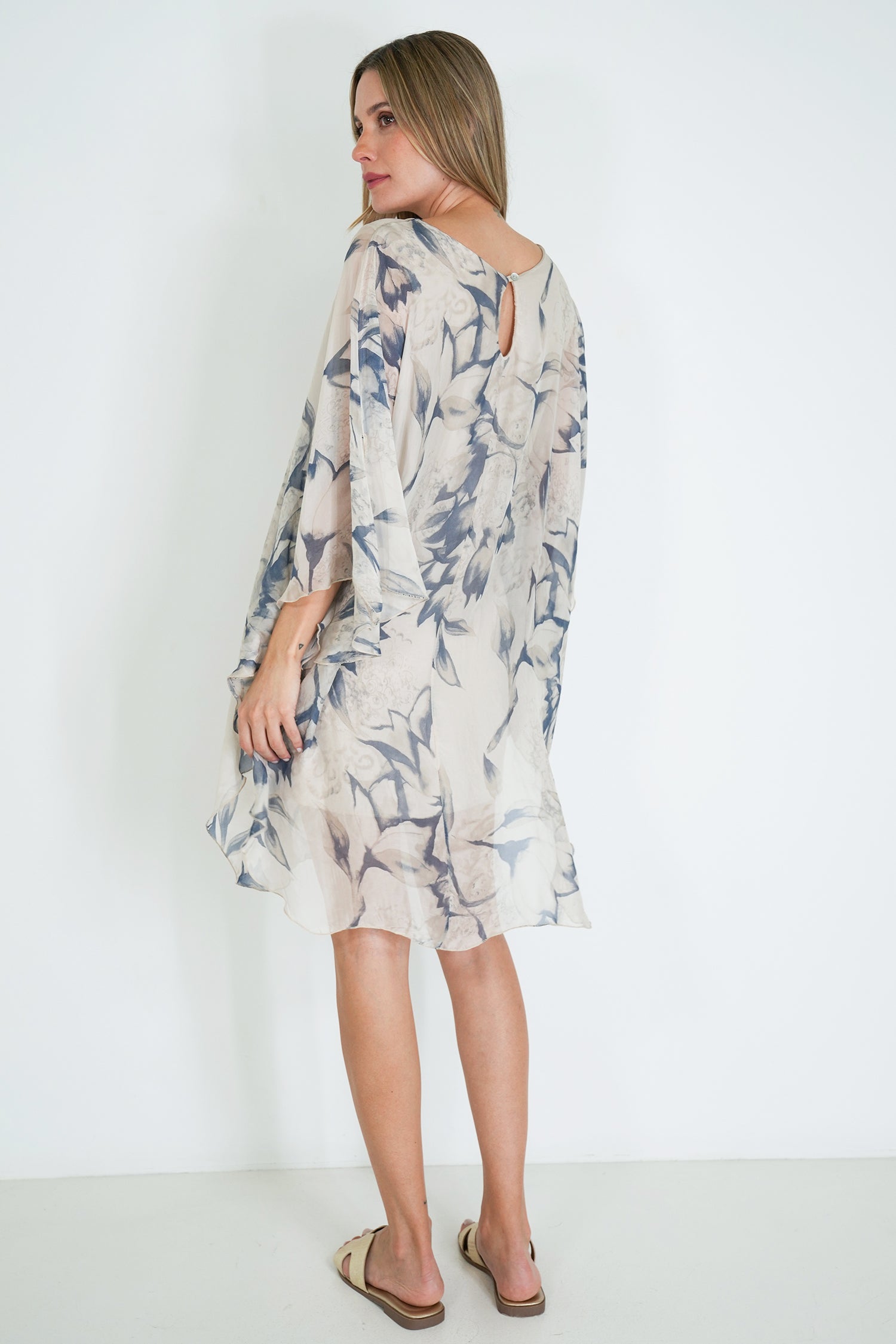 Woman wearing a floral dress against a white background