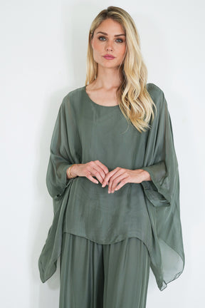 Woman wearing a green dress against a white background