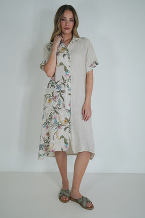 Woman wearing a floral dress with a plain background