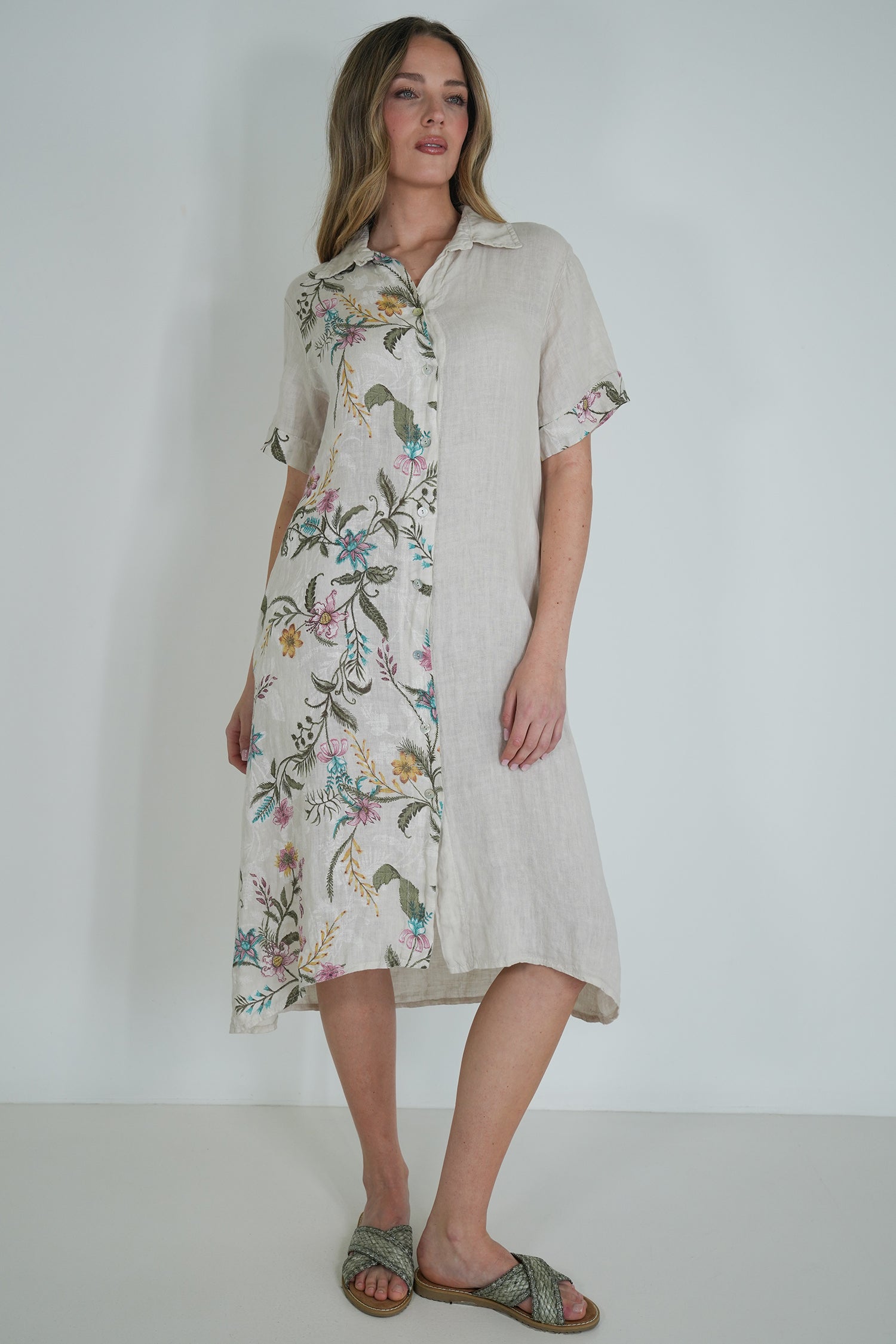 Woman wearing a floral dress with a plain background