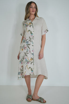 Woman wearing a floral dress with a plain background