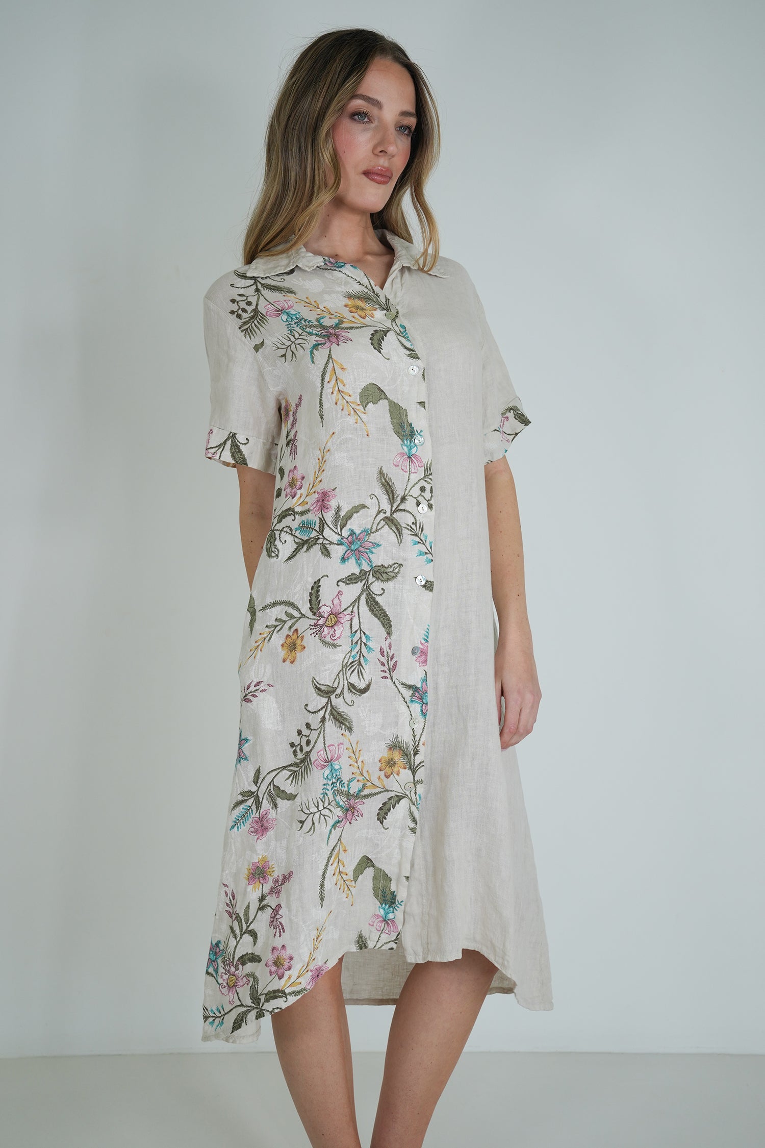 Woman wearing a floral dress with a plain background