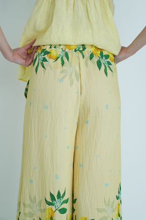 Yellow outfit with floral patterns on a plain background