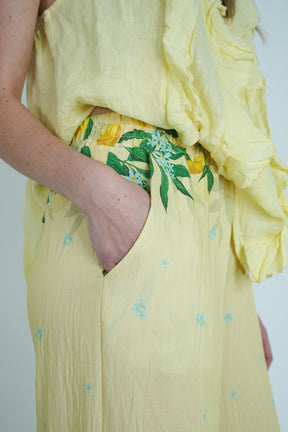 Yellow dress with floral design on a plain background