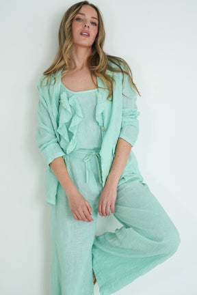 Woman wearing a mint green outfit against a white background