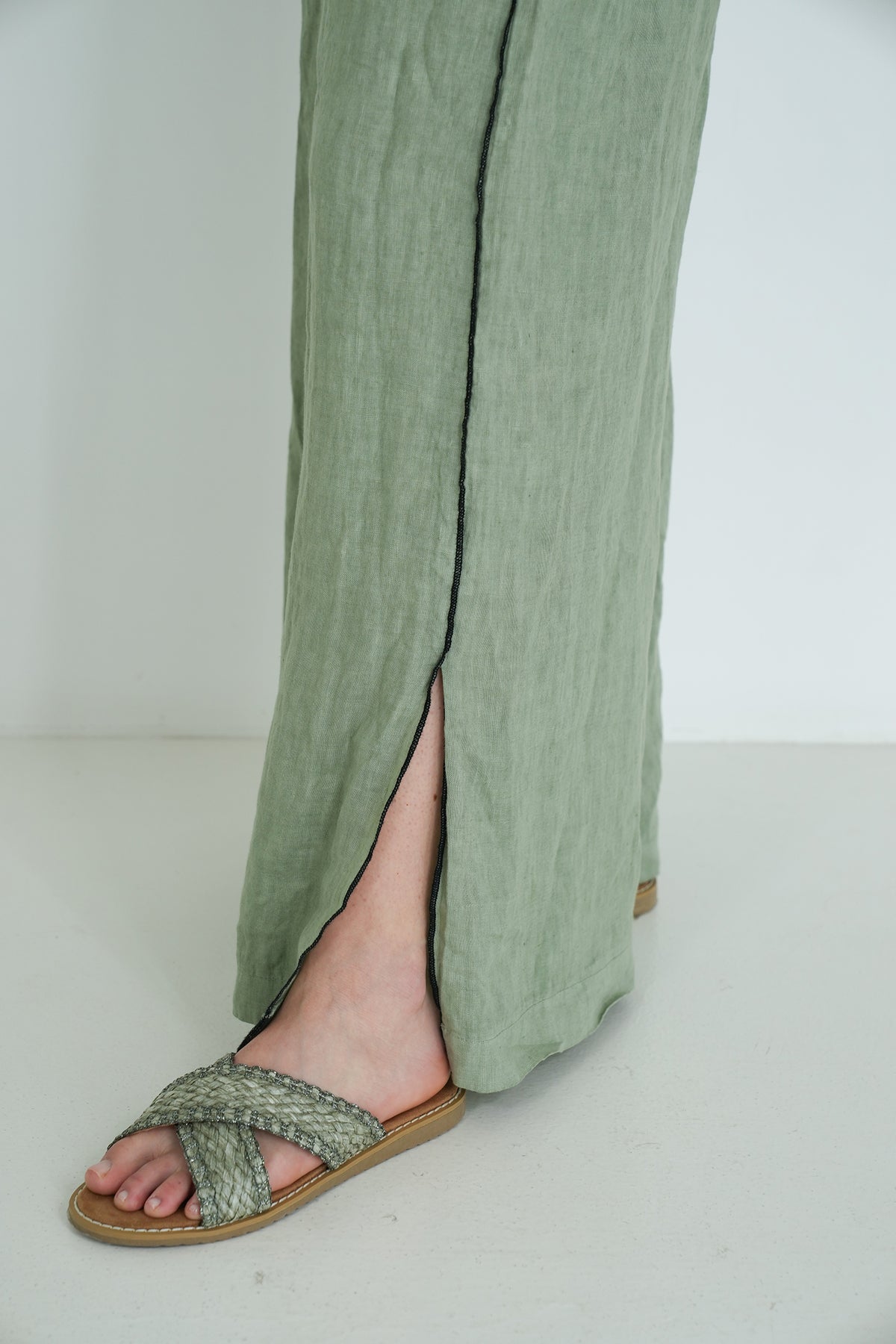 Green pants with a sandal on a white background