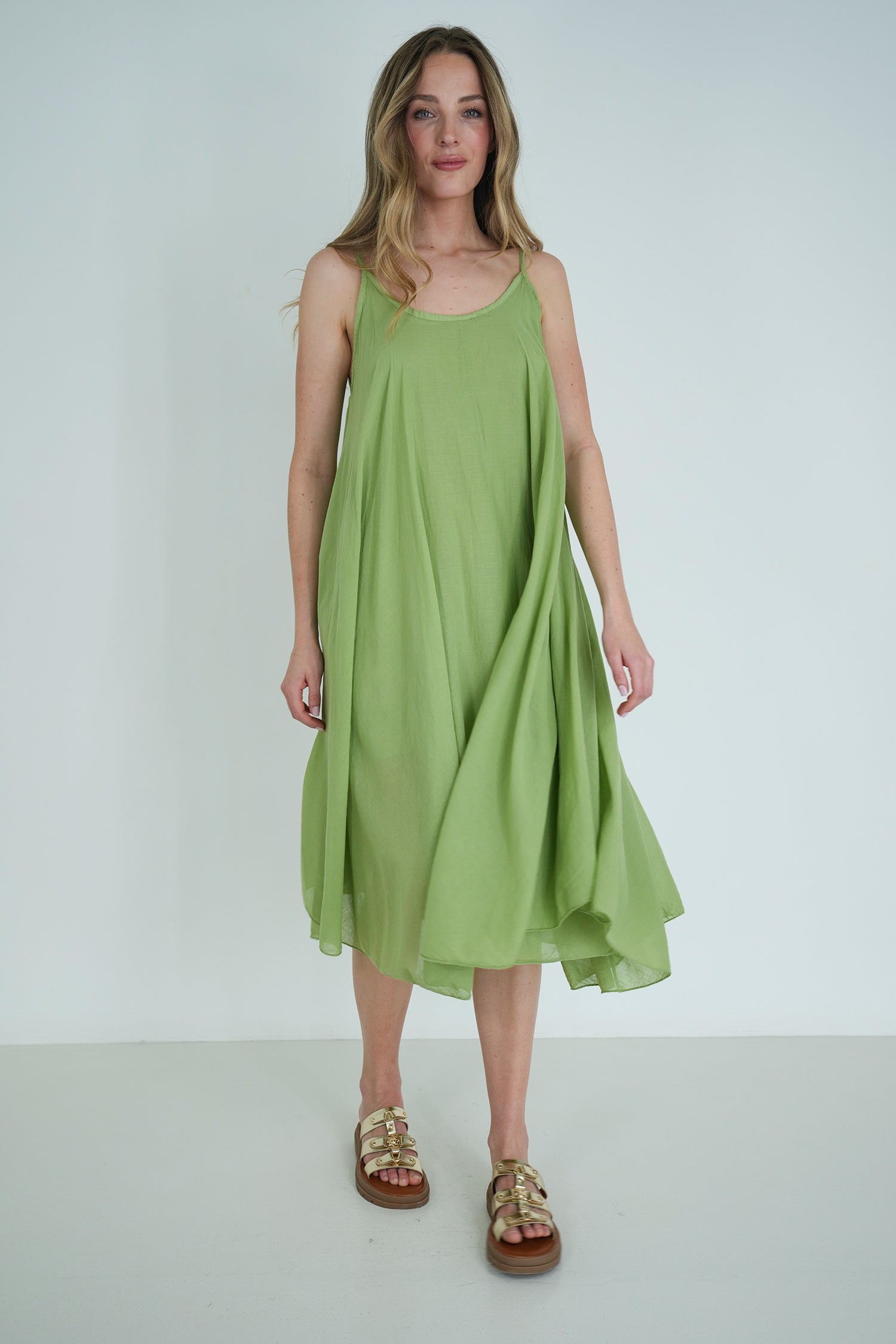 Woman wearing a green dress against a white background