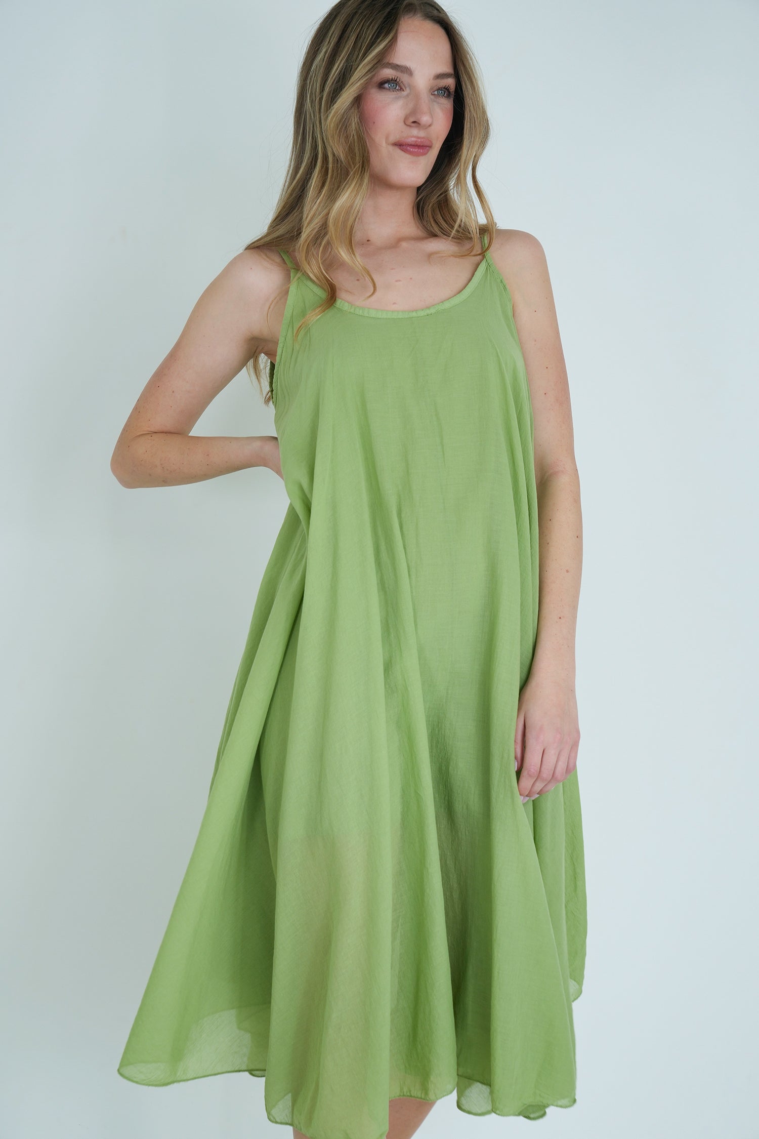 Woman wearing a green dress against a white background